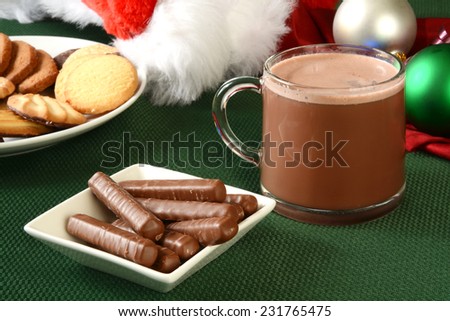 Milk chocolate orange sticks with hot chocolate and Christmas cookies