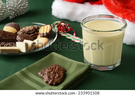 Assorted gourmet Christmas cookies with a glass of egg nog