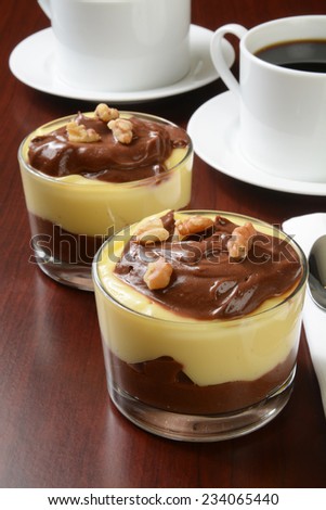 Dessert cups of vanilla and chocolate pudding topped with walnuts