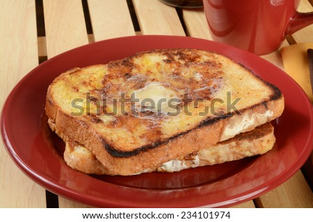 Hot buttered french toast with a cup of coffee