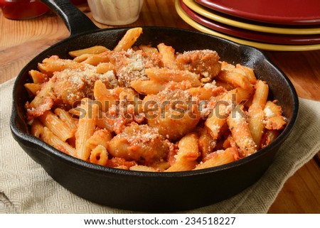 Chicken parmigiana and penne in a cast iron skillet