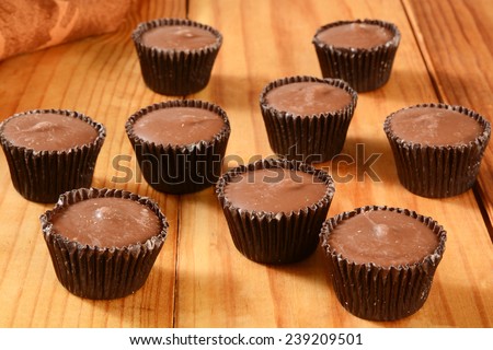 Small peanut butter cups on a rustic wooden table