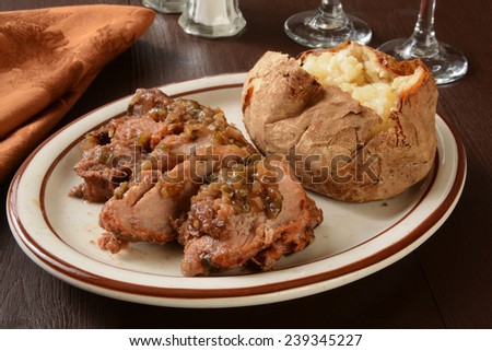 Savory pork shoulder roast with a baked potato in a ginger scallion sauce