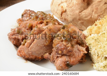 Close up of pork shoulder roast with a ginger scallion sauce