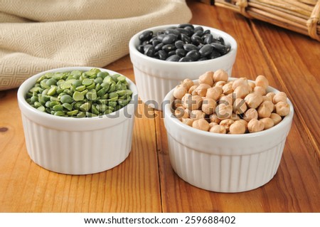 Small bowls of split peas, black turtle beans and garbanzo beans