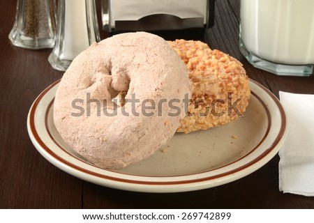 Assorted cake donut closeup with a glass of milk