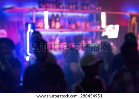 Abstract blurred image of people crowding the bar in a nightclub