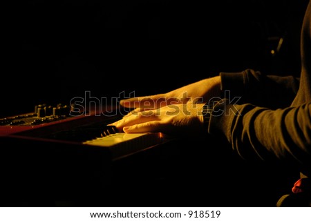 A closeup of pianist playing the keyboard during a live performance