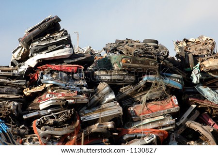 Old cars have been flattened for recycling in junkyard