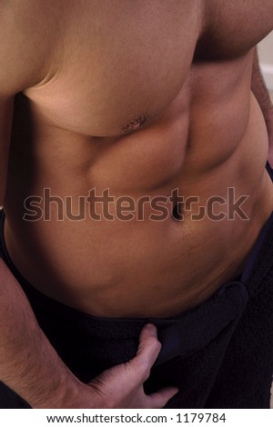 close up of pecs and abs