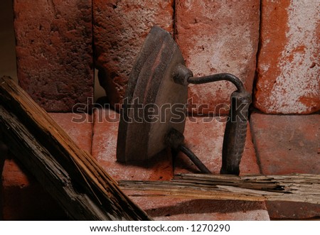 An old steel iron in a brick fireplace