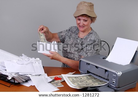 A woman cuts up counterfeit money to pay her bills