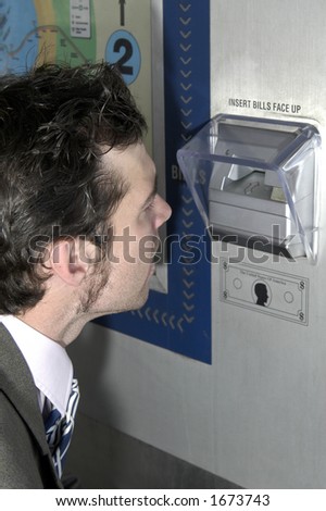 Man looking in ticket machine to see why it didn\'t give him ticket