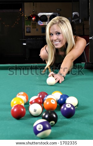 Beautiful girl making a pool shot