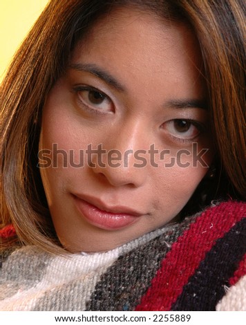 A woman snuggled up with a blanket
