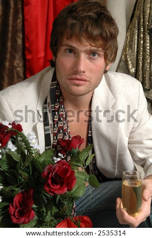 A handsome man holding roses and champagne