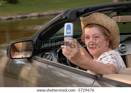 A woman sending pictures of her vacation from a cell phone