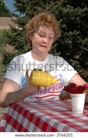 A woman at a highway rest stop enjoying a picnic lunch
