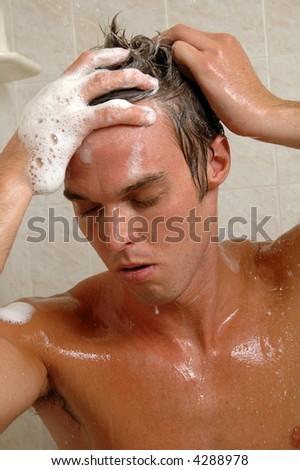A sexy man washing his hair i the shower
