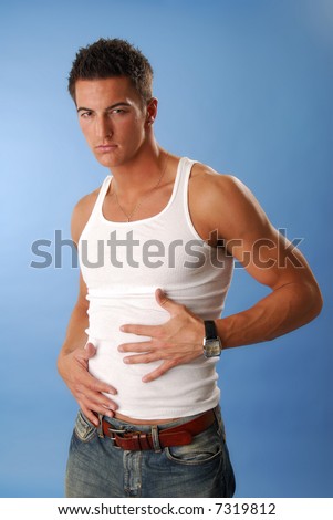 stock photo A slender young man rubs his hands on his stomach