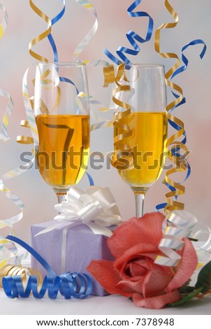 Party Ribbon falls abound champagne glasses and a gift