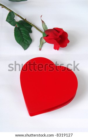 stock photo : A heart shaped box of chocolates and a single rose