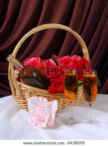 A basket of red roses and wine