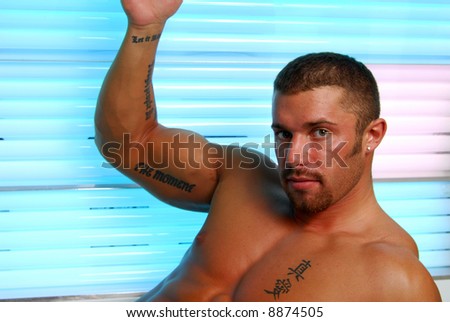 A muscular man in a tanning bed