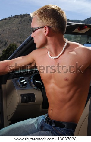 A handsome young man on a summer afternoon getting out of a car