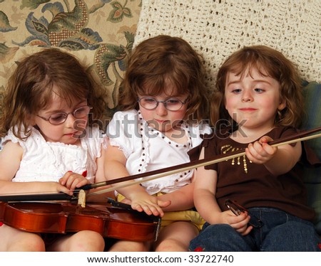 Triplets playing with a violin