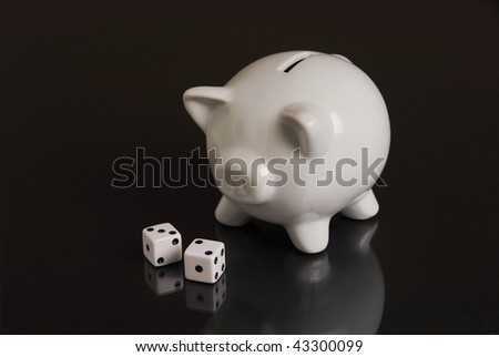 Dice in front of a piggy bank representing a gamble of your savings
