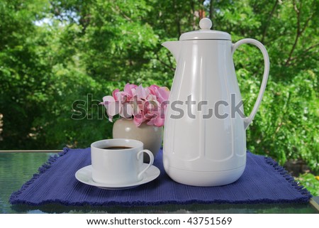 A pot of coffee served outdoors on the patio