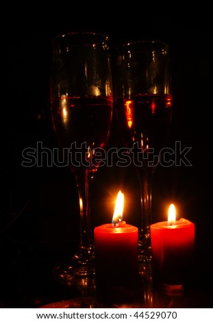 Candles and wine glasses suggesting romance, love or Valentine\'s day