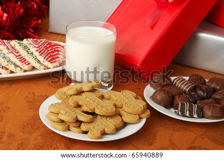 Plates of cookies, chocolates and a glass of milk left out for Santa