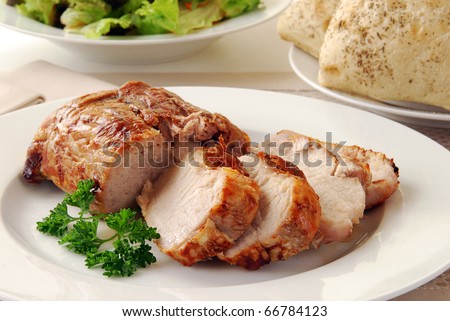 A juicy fresh pork loin roast sliced on a plate