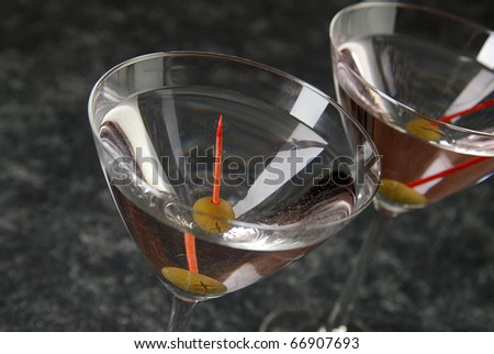 Two martinis with stuffed green olives