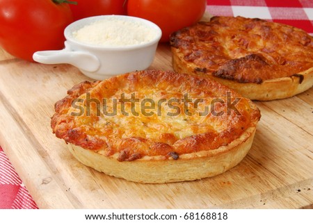 An individual serving size pizza and ripe tomatoes