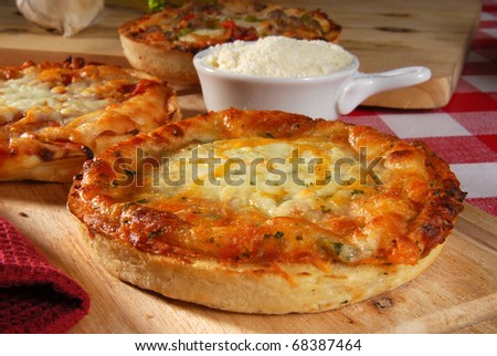 Individual serving sized cheese and supreme pizzas