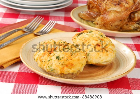 Dinner set out of twice baked potatoes and roasted chicken