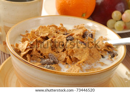 A continental breakfast of cereal, coffee and a bowl of fruit