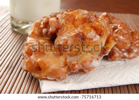 Deep fried apple fritters and a glass of milk