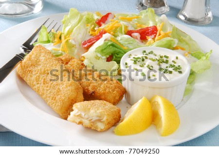 Golden brown fish sticks with salad