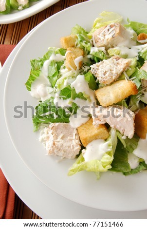 Close up photo of a Caesar salad with chicken