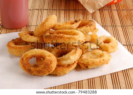 Fresh onion rings on a sheet of white paper