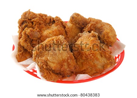 a red basket of fried chicken