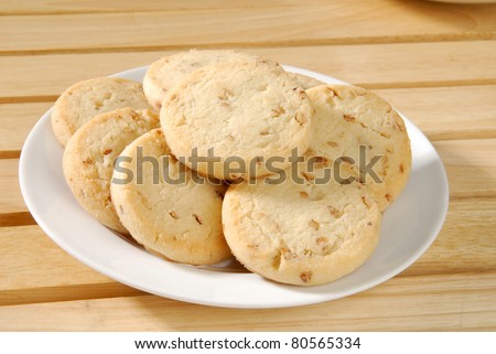 A plate of short bread cookies with pecans