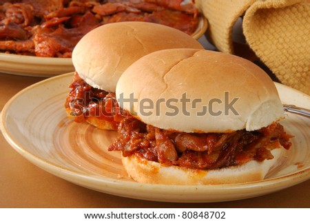 Two barbecue beef sandwiches on buns
