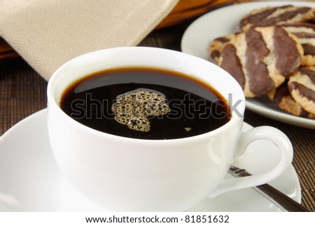 A cup of after dinner coffee with oatmeal and fudge stripe cookies