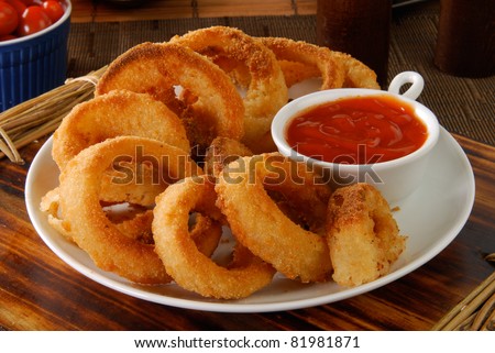 A plate of onion rings with catchup