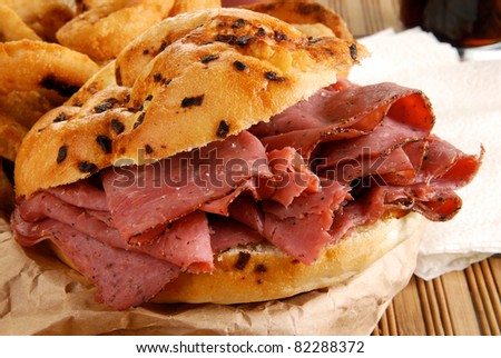 A roast beef sandwich on an onion bun
